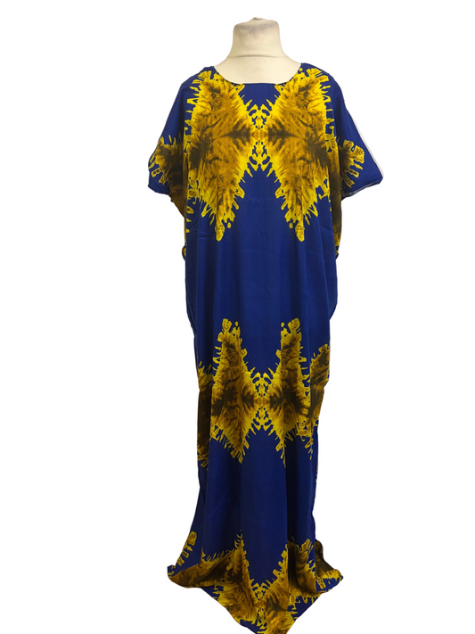 A blue kaftan dress with a bold yellow and brown tie-dye geometric pattern, displayed on a mannequin in front of a white fabric backdrop.
