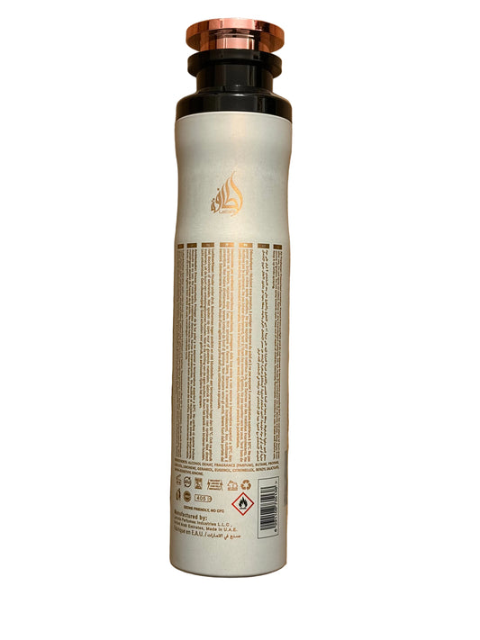 A tall cylindrical bottle with a metallic rose gold cap and a cream-colored body, featuring a gold flame logo and dense black text on the back label, isolated on a white background.