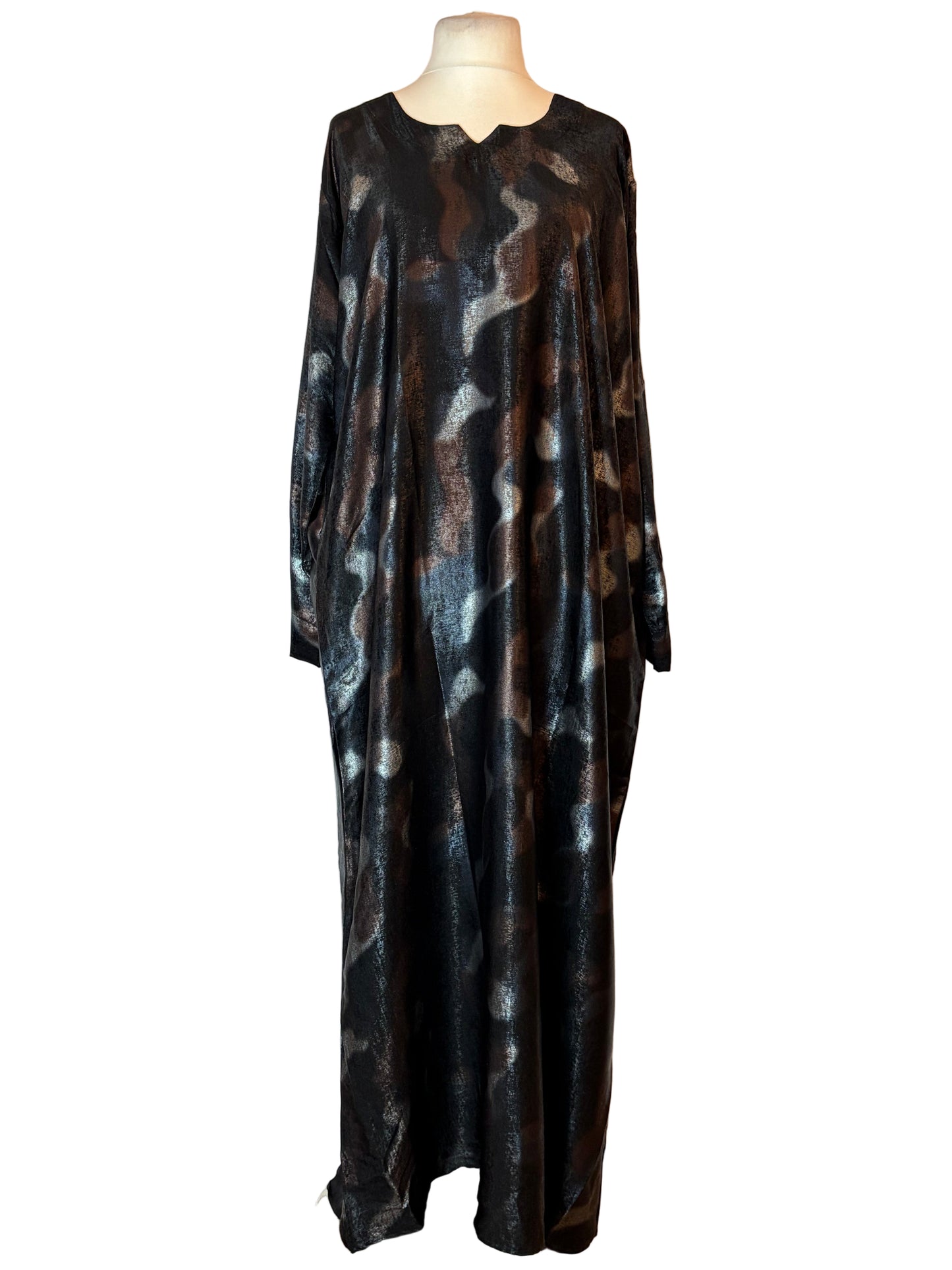 Long, dark-colored Abaya dress with abstract pattern on a white background