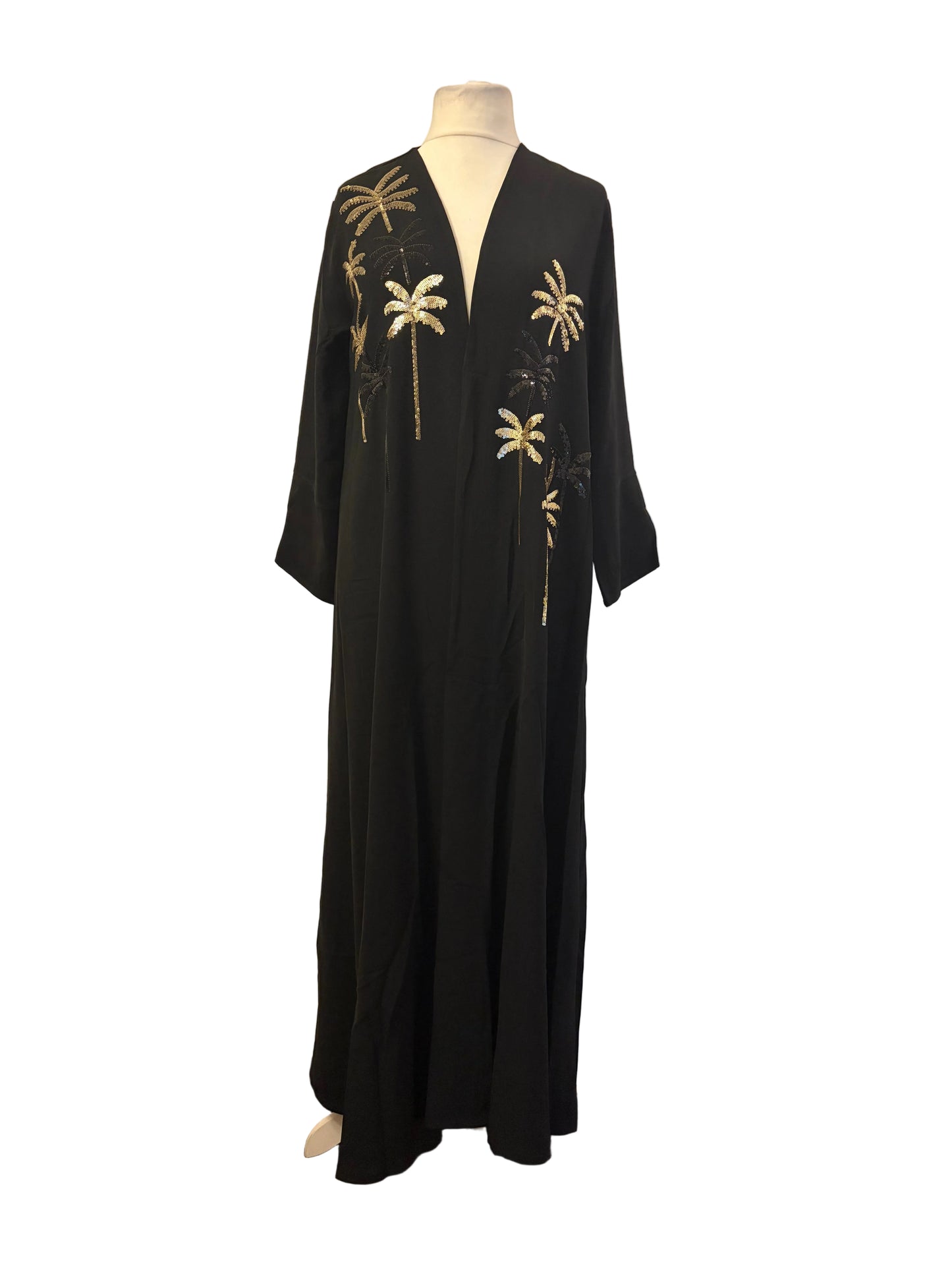 Black Abaya dress with gold floral embroidery on a mannequin against a white background