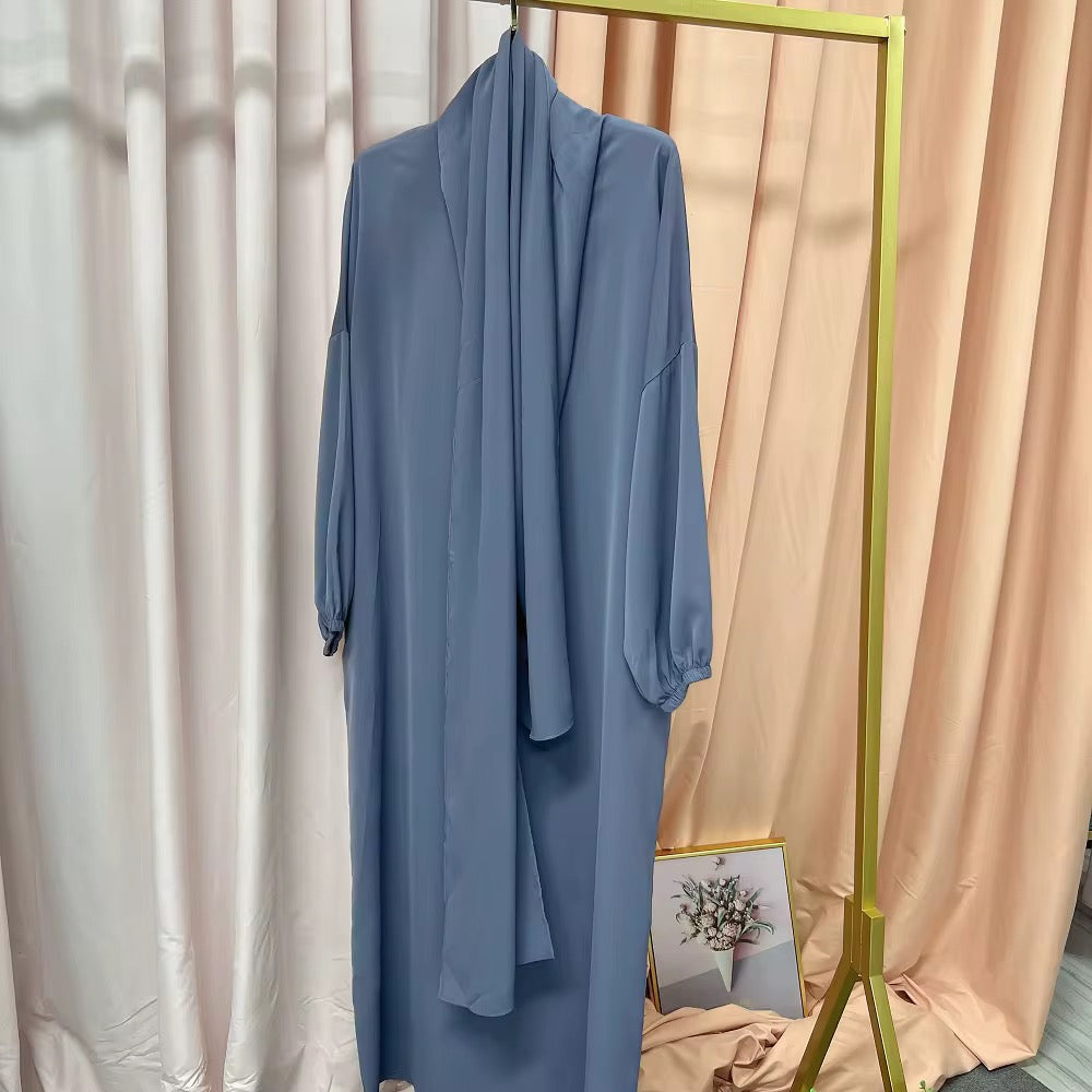Gray abaya dress on a rack with a neutral background
