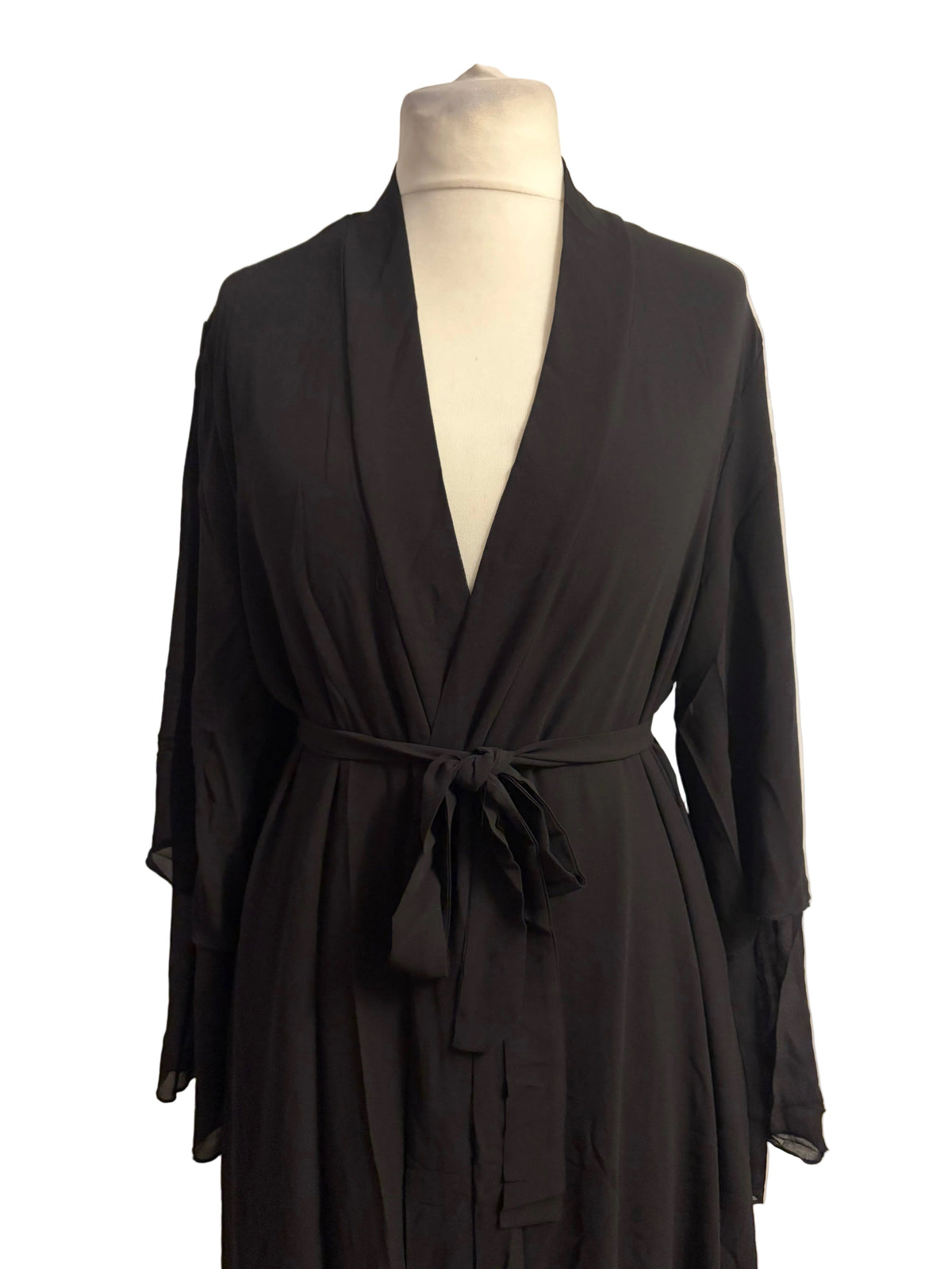 Black robe on a mannequin against a white background