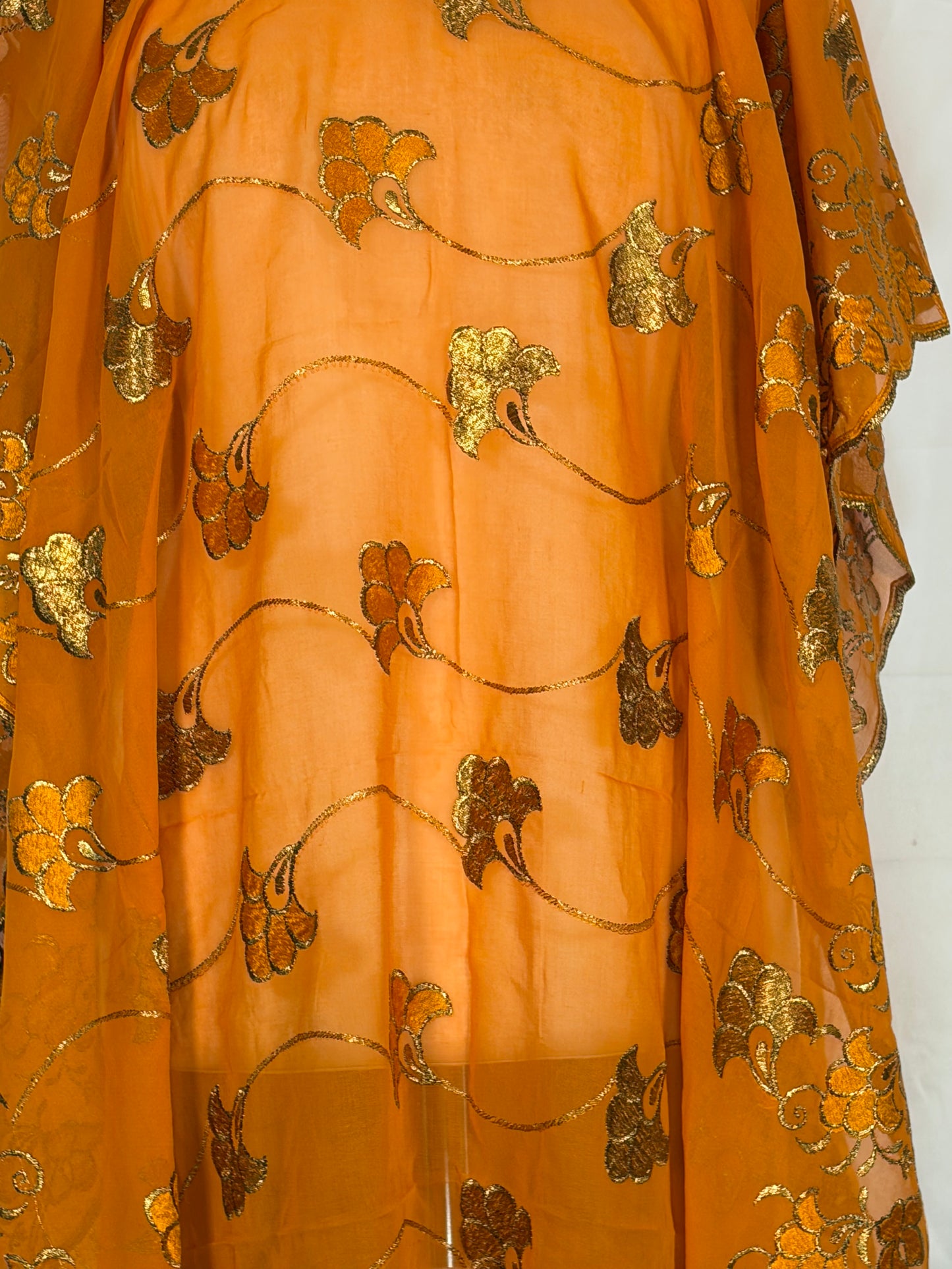 Gold fabric with floral patterns on a white background