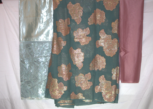 Three pieces of Somali dirac fabric with different patterns and colors on a white background