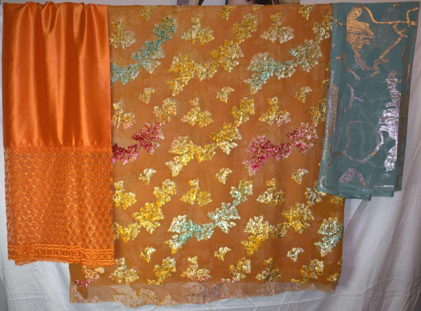 Dirac - Three pieces of fabric with different patterns on a white background