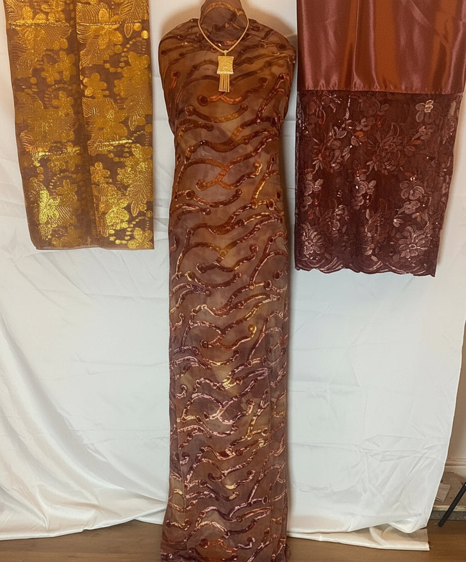 Brown textured Somali Dirac fabric with gold patterns on a white background