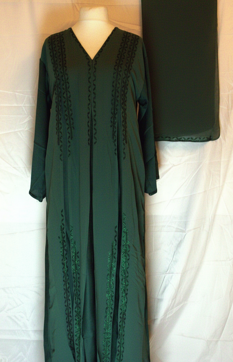 Green dress with black lace details on a mannequin against a white background