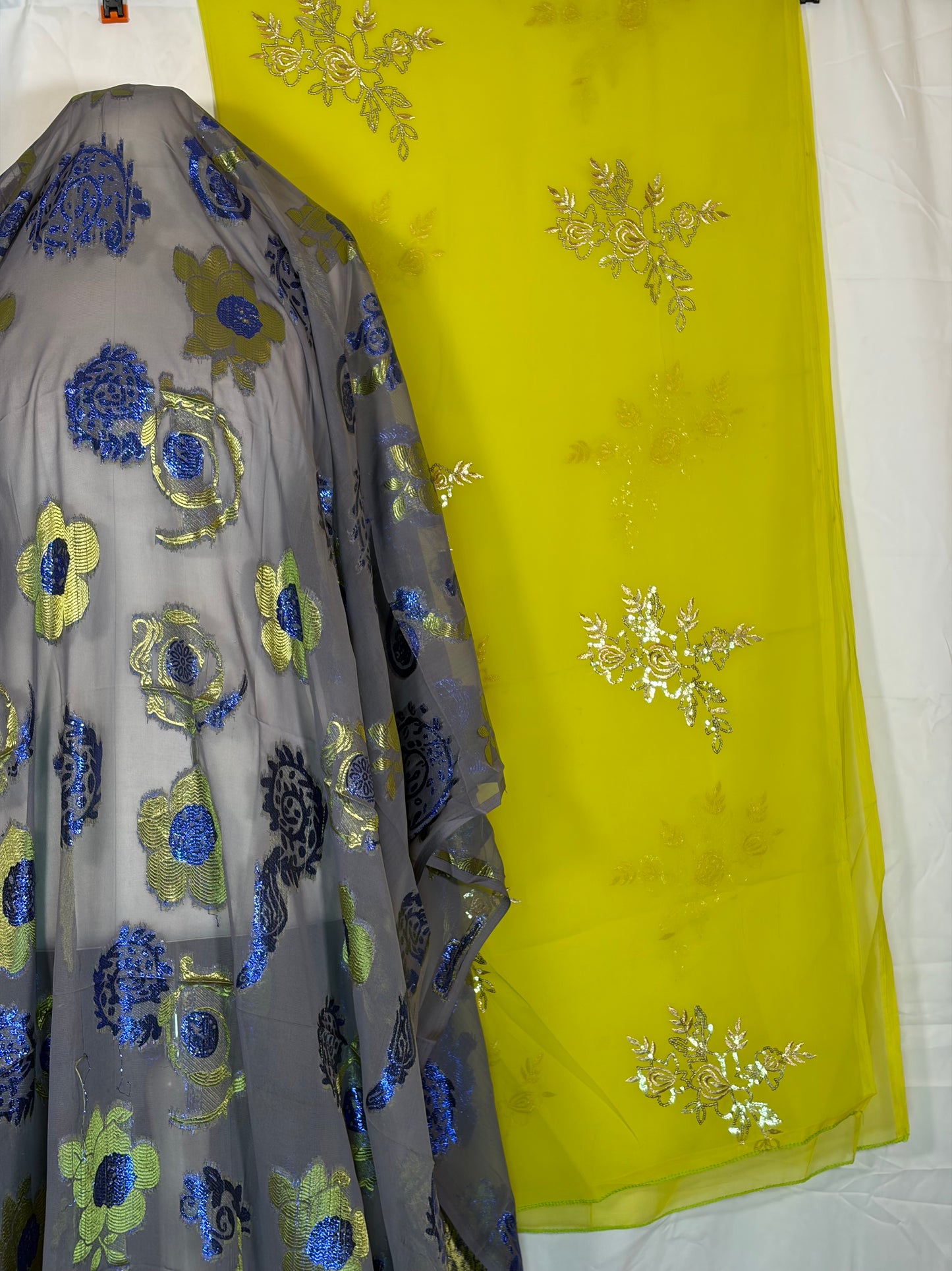 Yellow fabric with floral embroidery on a white background