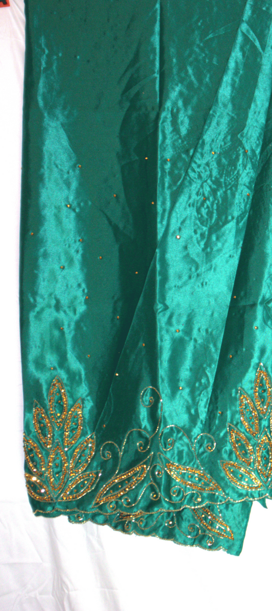 Teal Gorogard fabric with gold embroidery on a white background