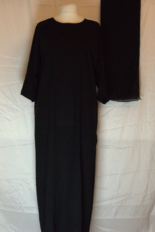 Black dress on a mannequin against a white background