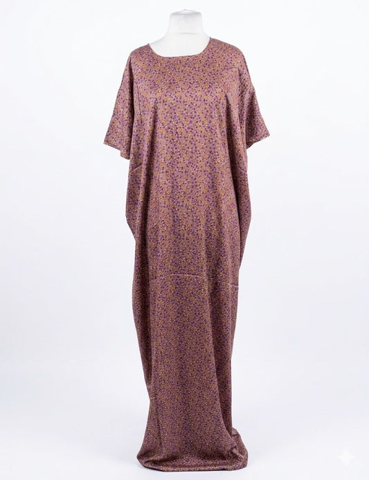 Long, flowing Somali baati dress with a subtle pattern on a white background
