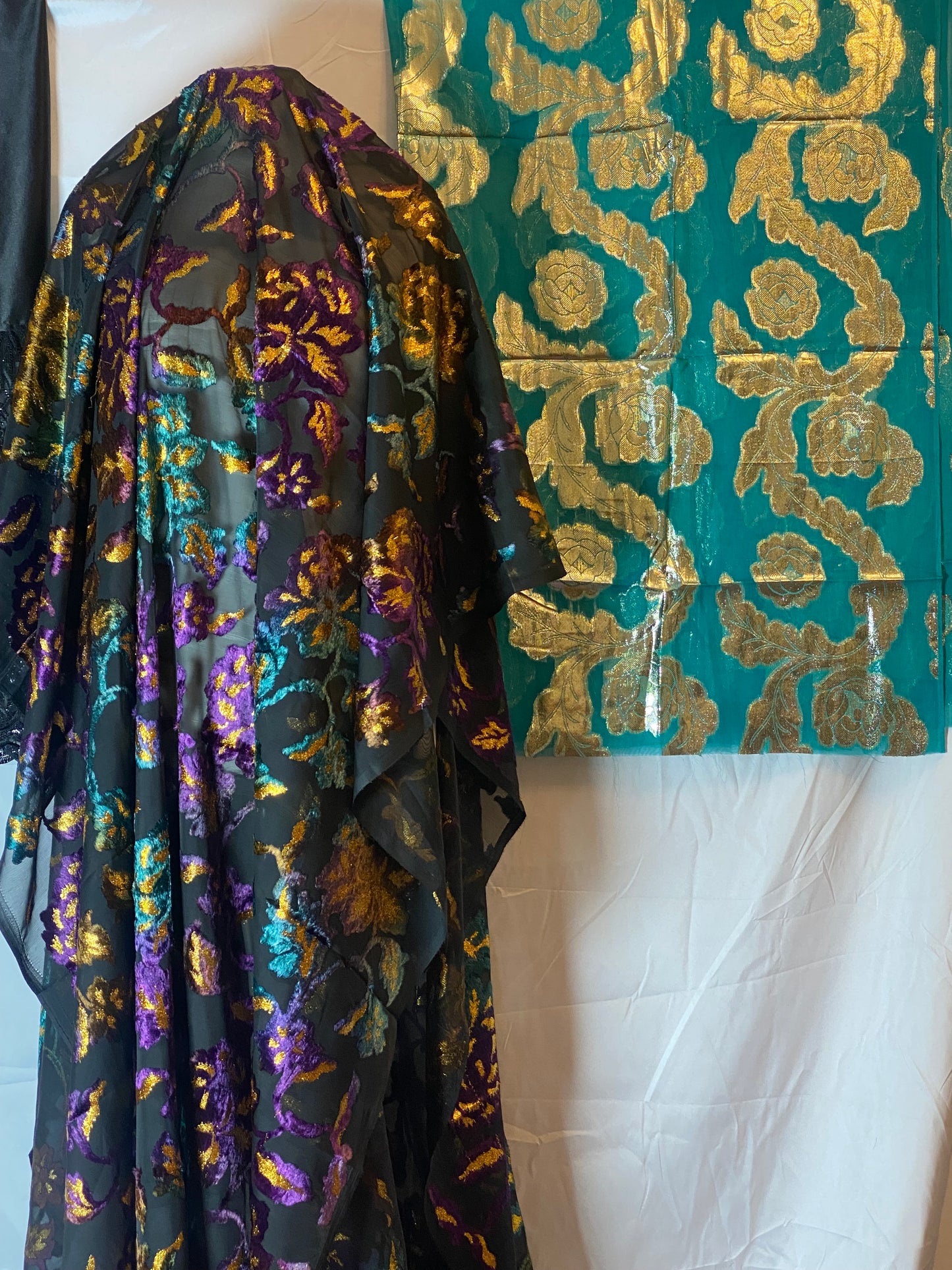 Maqbal Dirac fabric with gold and purple patterns on a white surface