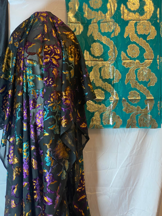 Maqbal Dirac fabric with gold and purple patterns on a white surface