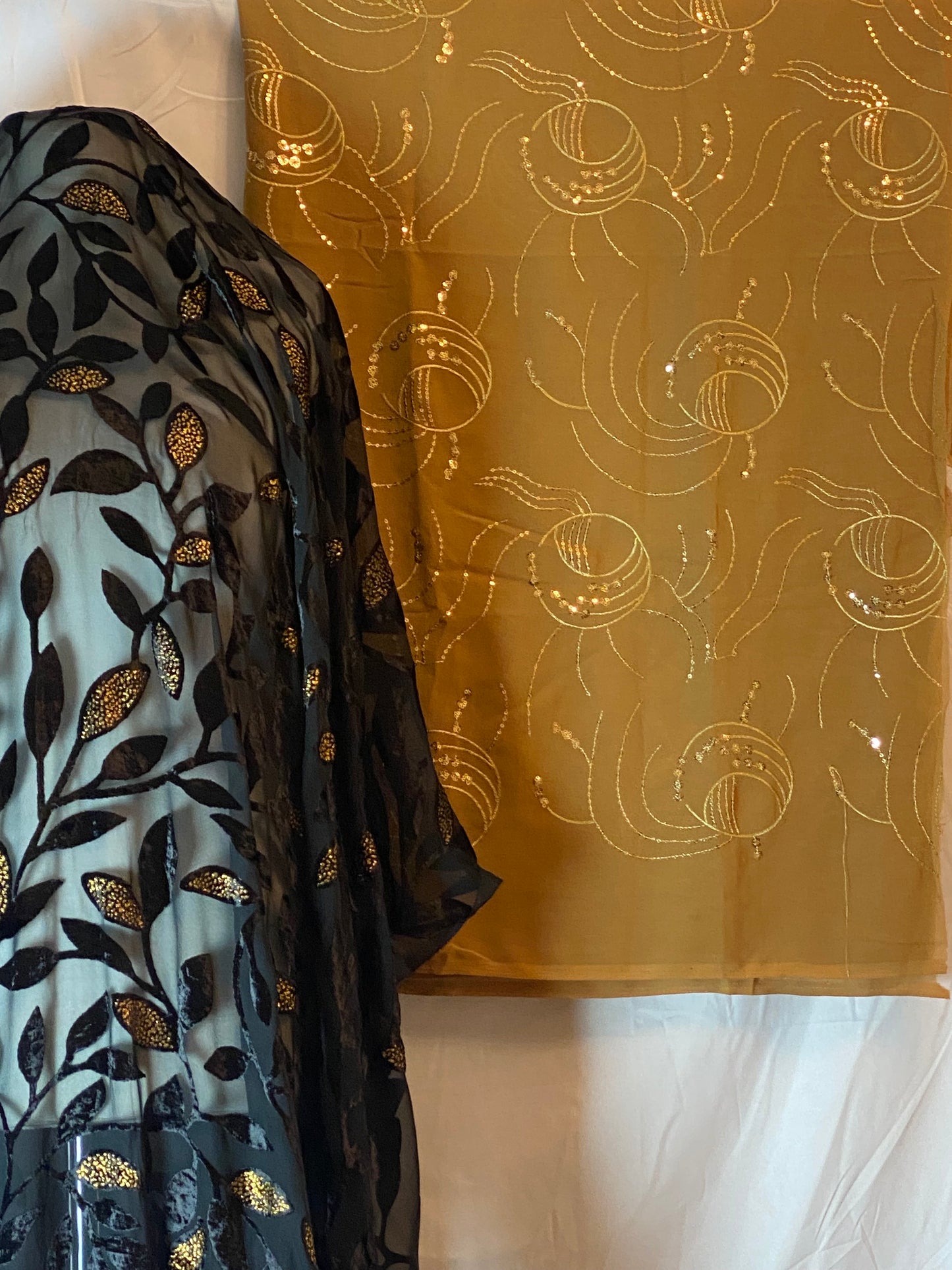 Gold Gabasaar fabric with intricate patterns on a white background