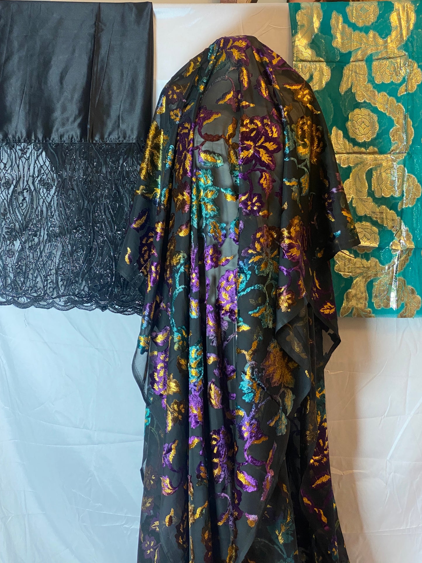 Maqbal dirac fabric with gold and purple patterns on a textured surface