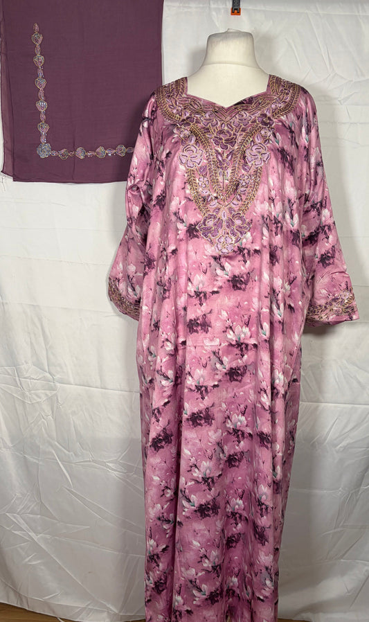 Purple floral Mukawarar dress on a mannequin against a white backdrop