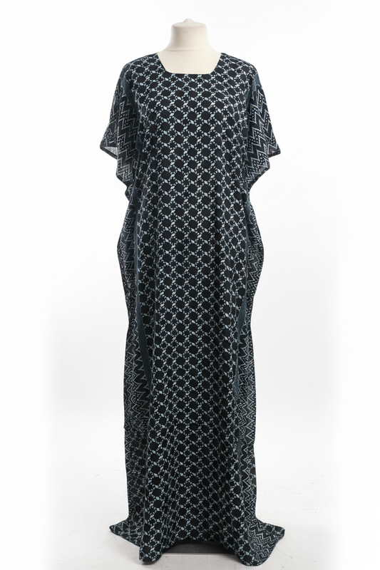 Black patterned Somali baati dress on a mannequin against a white background