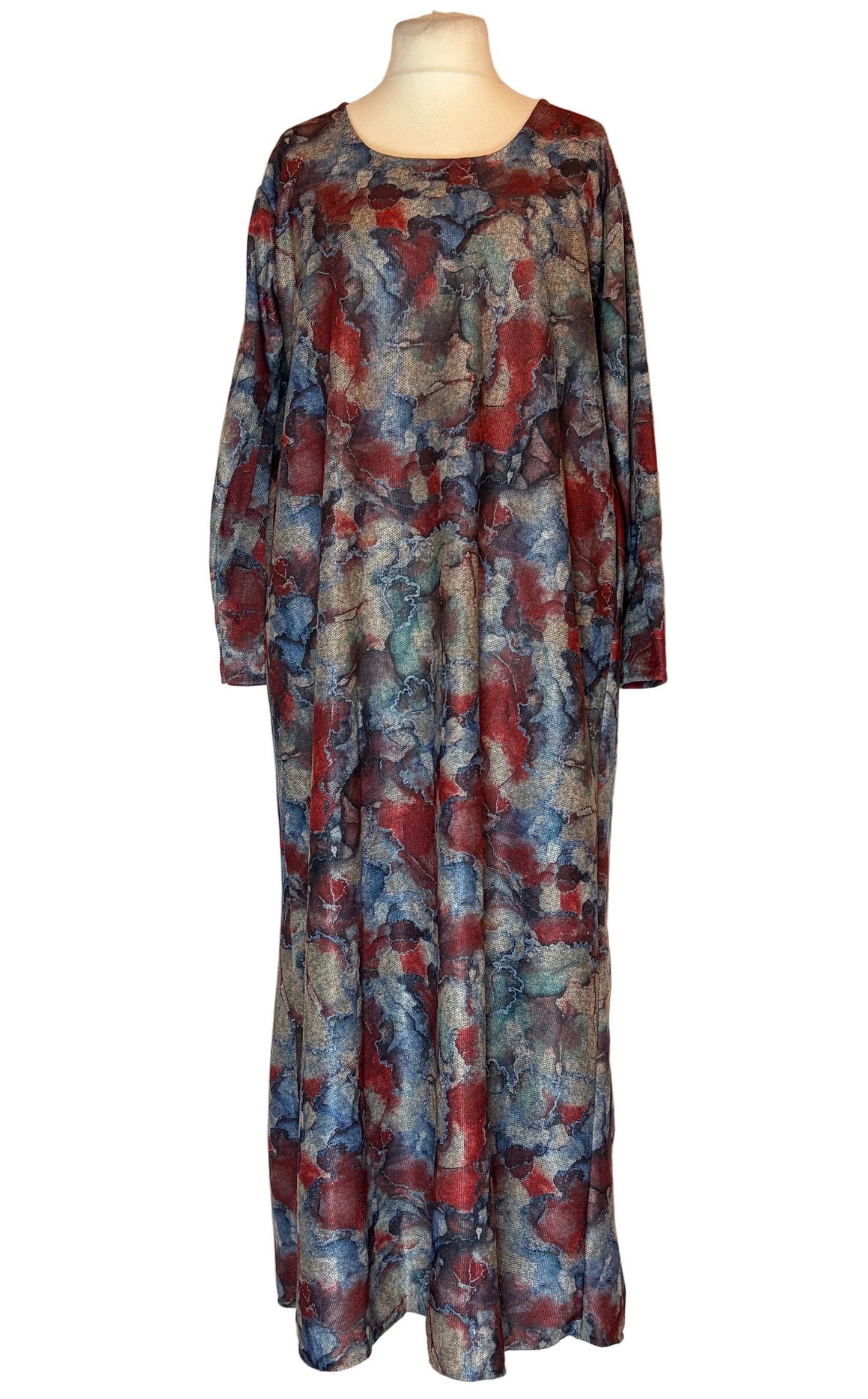 Long, patterned dress on a mannequin against a white background