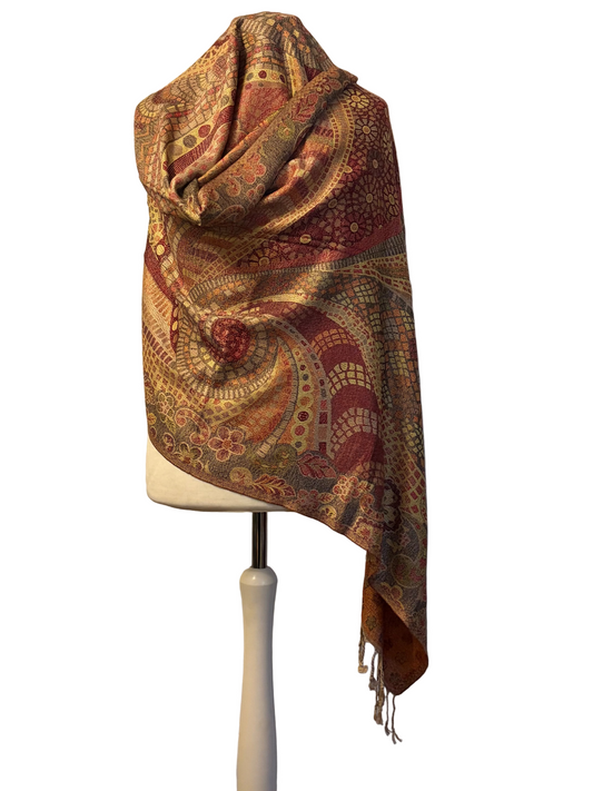 Colorful patterned scarf on a mannequin against a textured white background