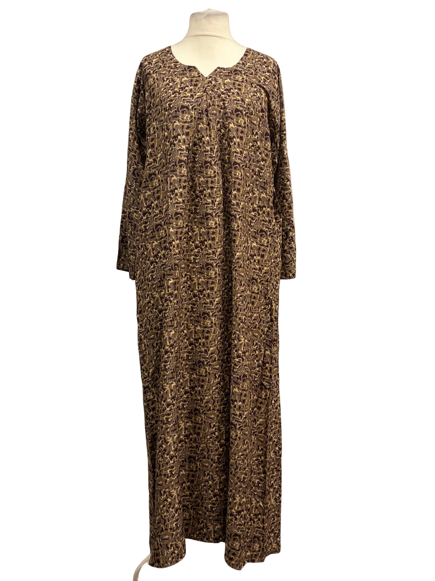 Long patterned dress on a mannequin against a white background