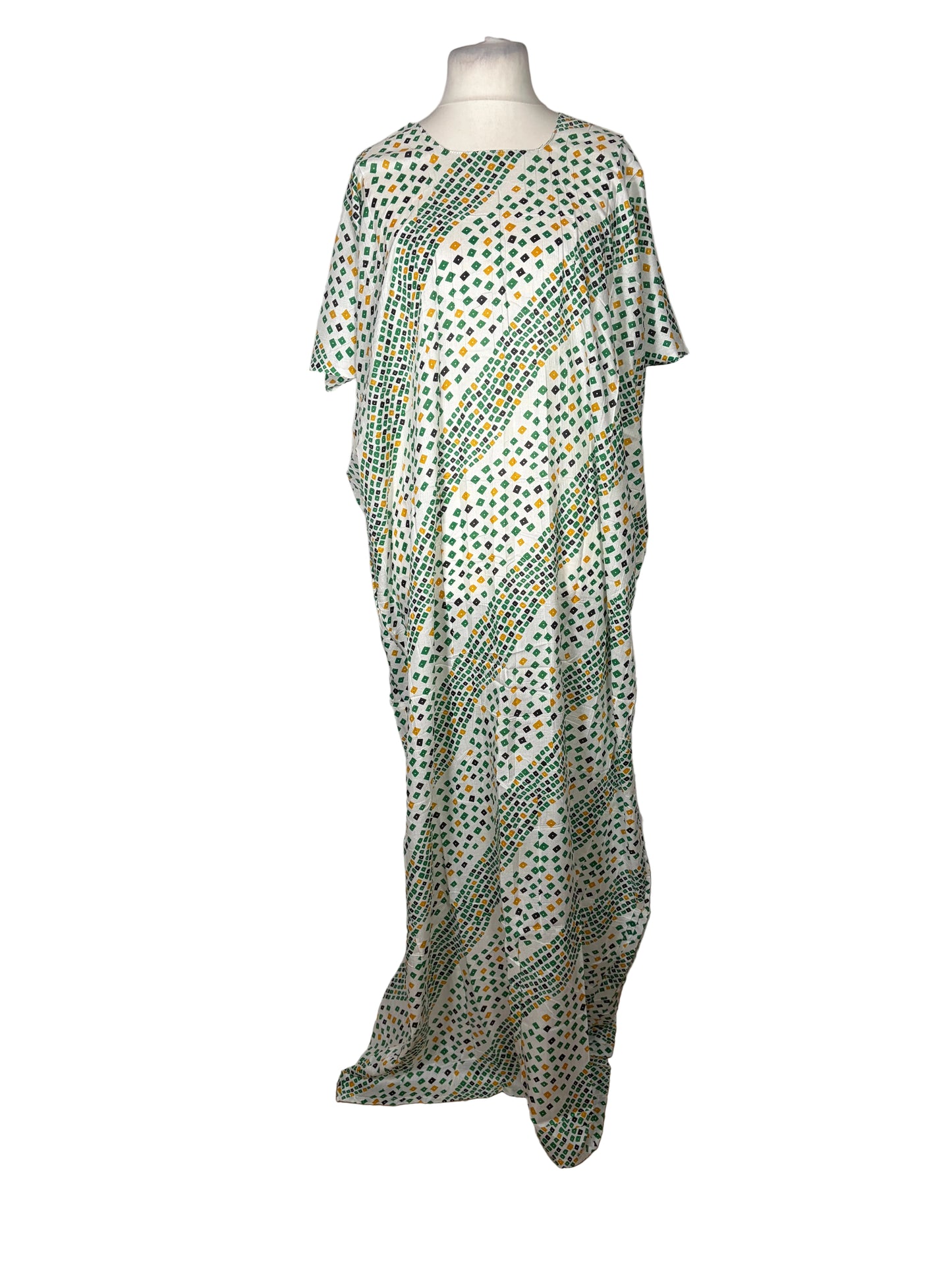 Green patterned dress on a mannequin against a white backdrop