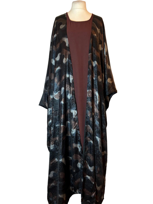 Leopard print Abaya on a mannequin against a white background