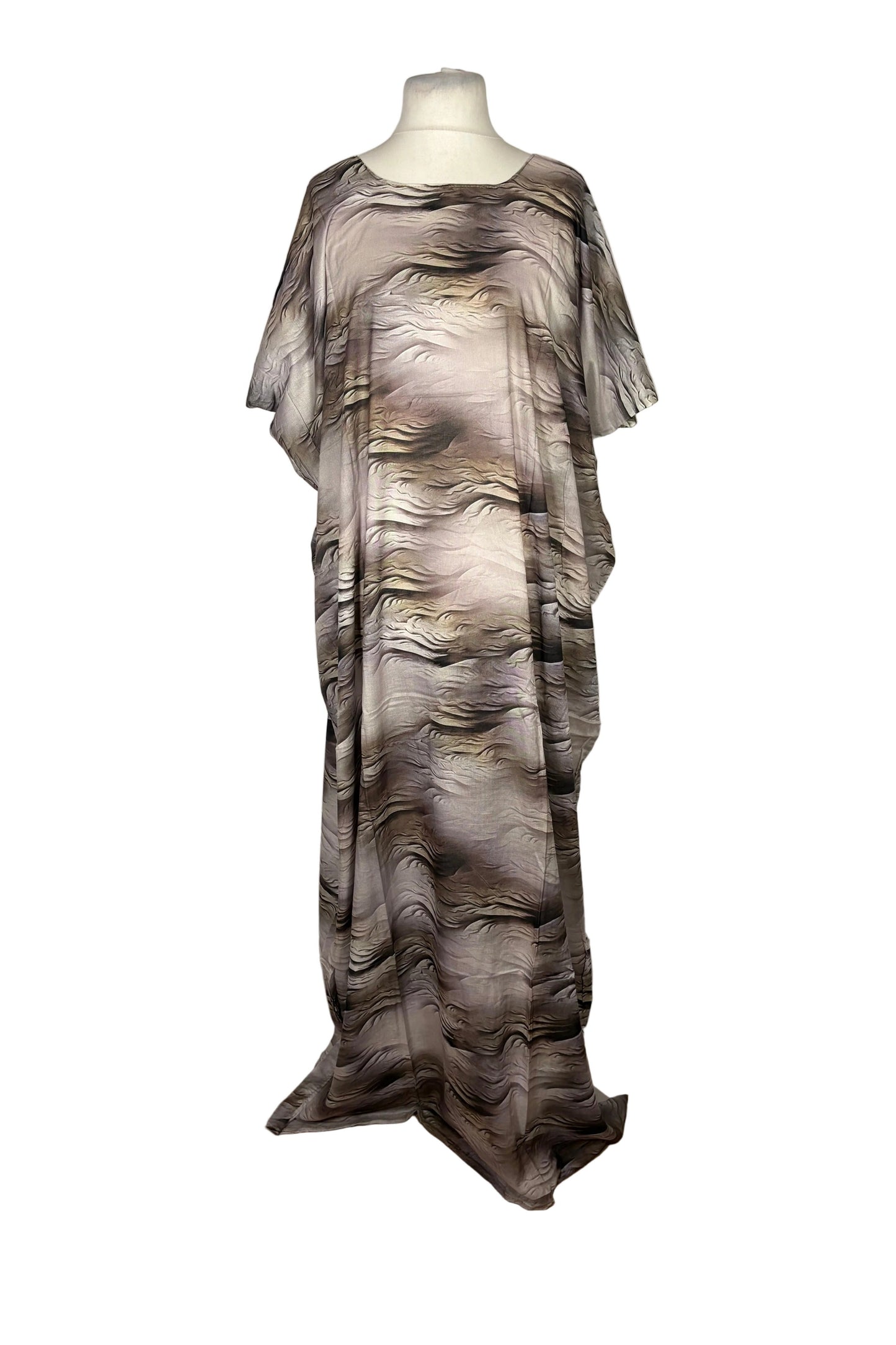 Mannequin wearing a long Somali Baati, patterned dress on a white backdrop