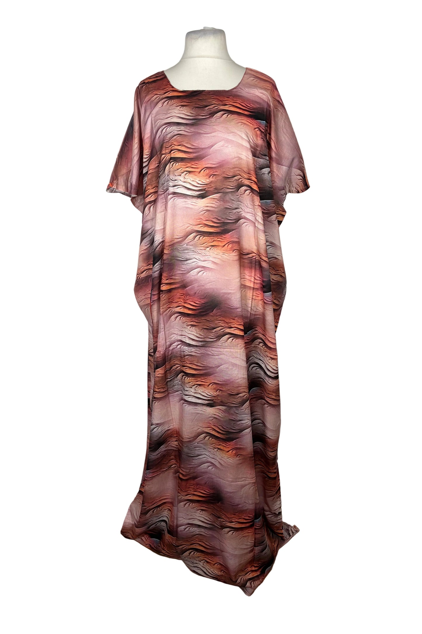 Mannequin wearing a long, patterned Somali Baati dress on a white surface.