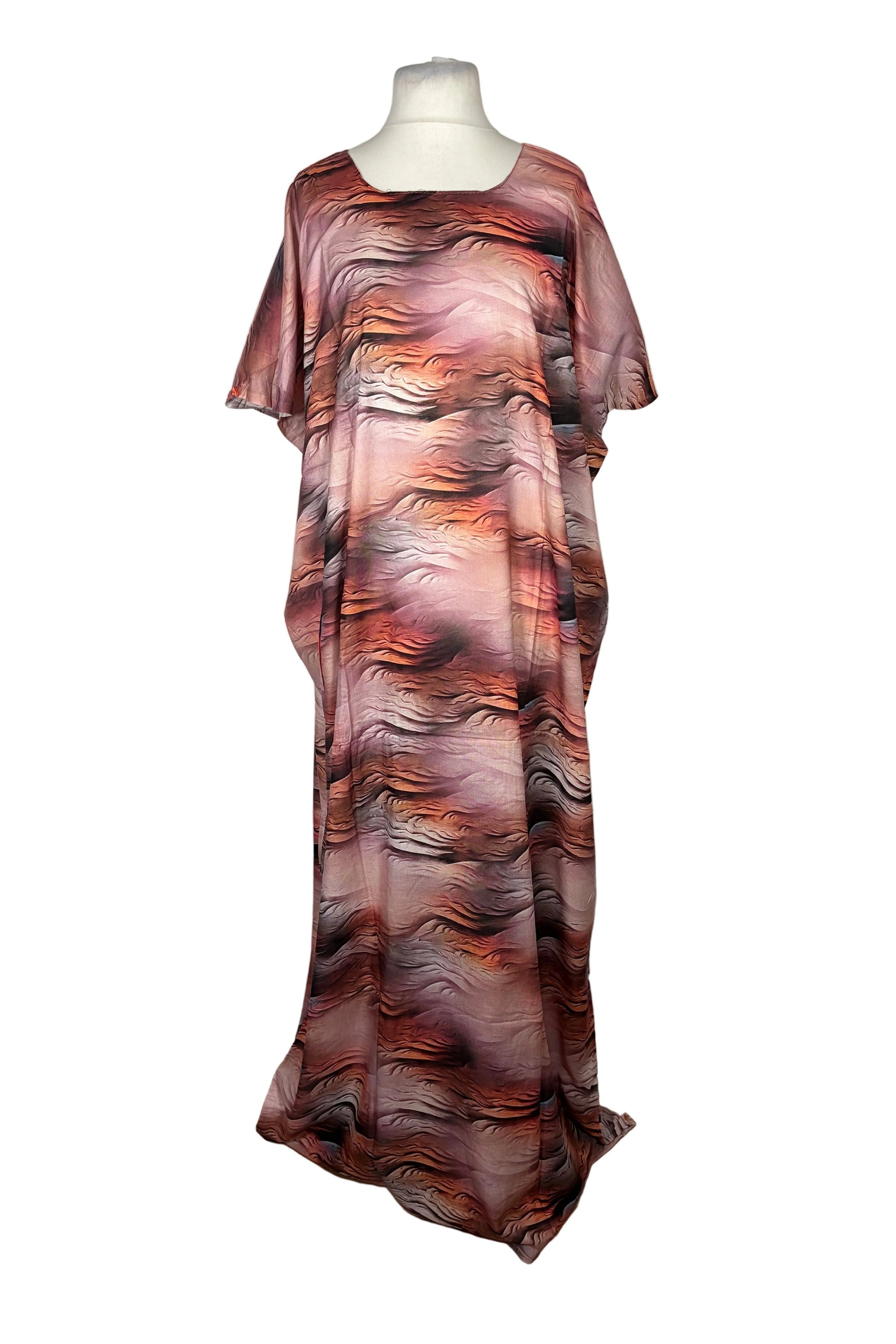 Mannequin wearing a long, patterned Somali Baati dress on a white surface.
