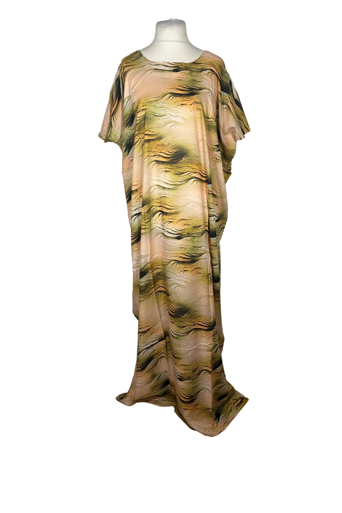 Long, patterned Somali Baati dress on a mannequin against a white curtain background