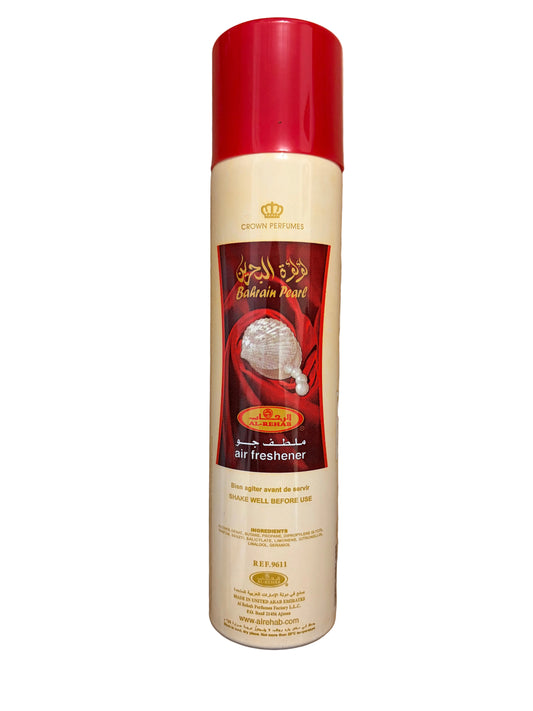 A can of Crown Perfumes Balmaine Pearl Air Freshener with a red cap and cream-colored body, placed on a wooden floor.