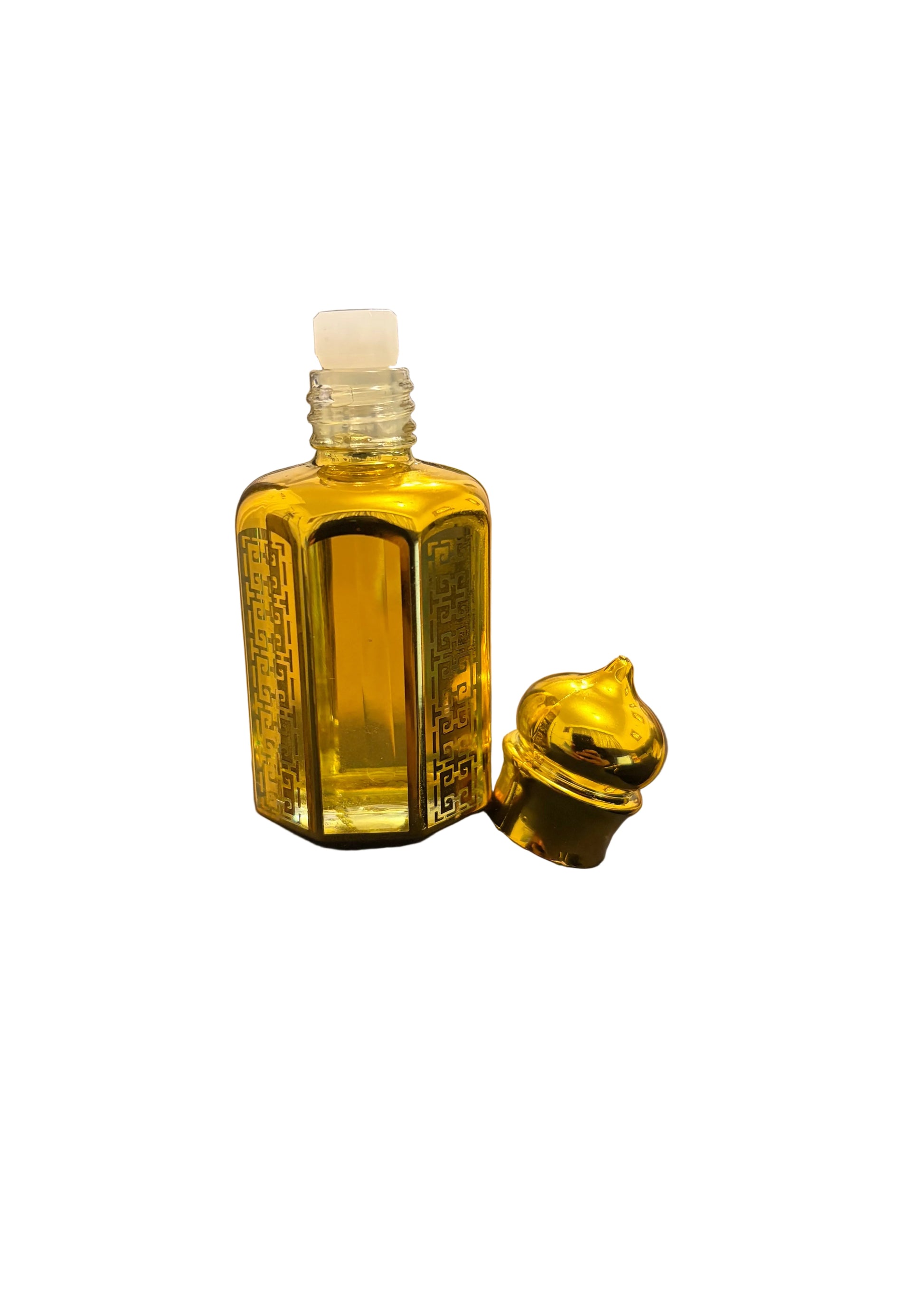 A small hexagonal bottle filled with yellow liquid, shown with its gold cap off and resting beside it. 