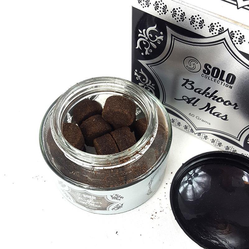Jar of brown Bakhoor with 'Solo Collection' packaging in the background