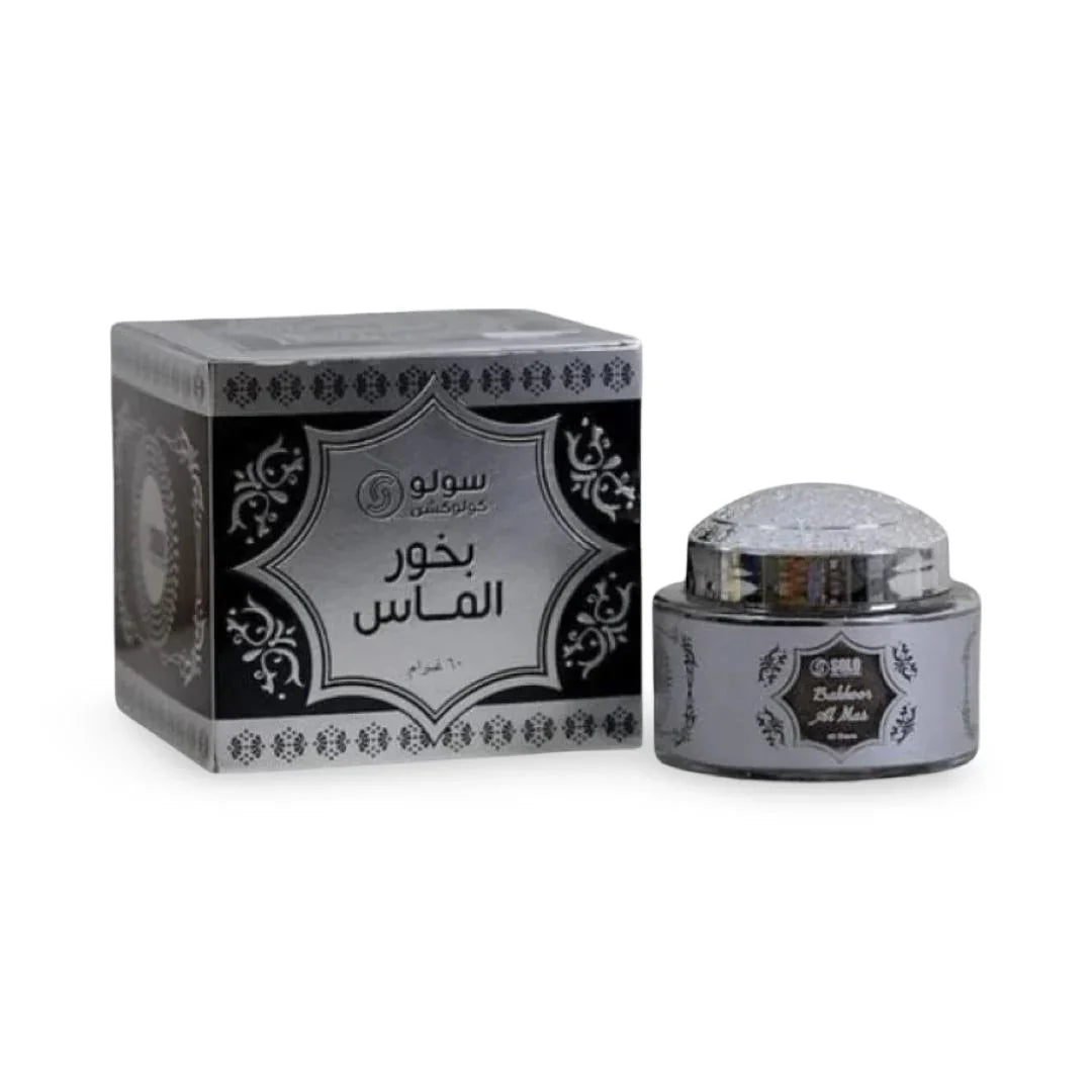 Silver and black container with Bakhoor on a white background