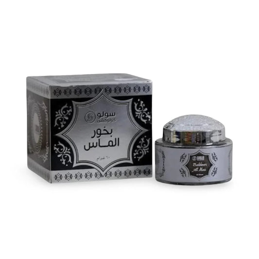 Silver and black container with Bakhoor on a white background