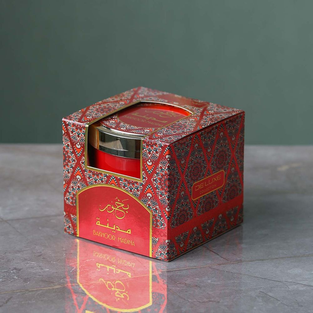 Decorative red box with Bakhoor on a gray surface