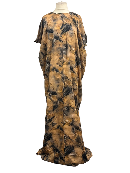 Long, patterned dress on a mannequin against a white backdrop