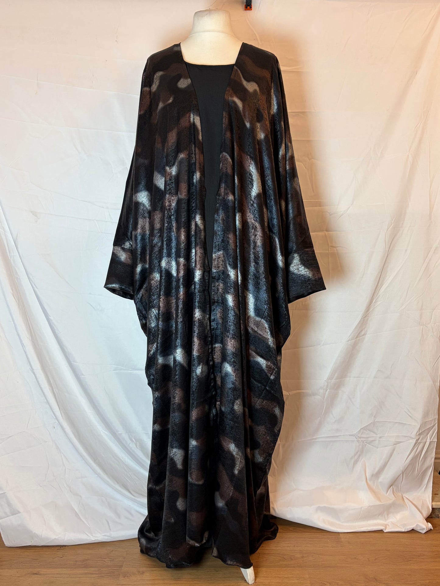Black patterned Abaya Kimono on a white surface