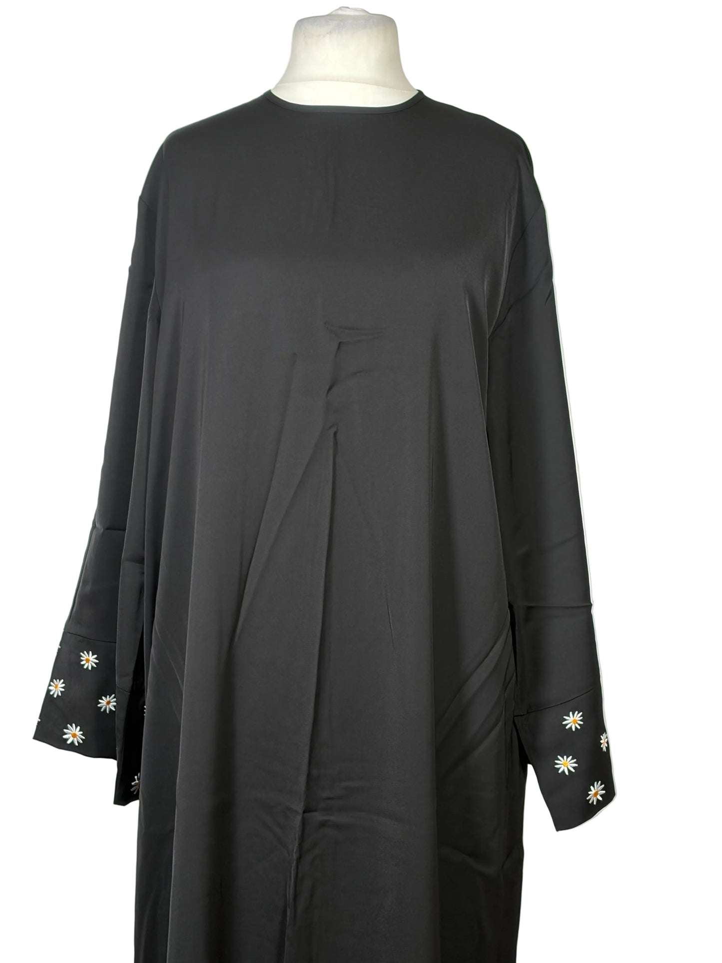 Black dress with floral embroidery on a white background