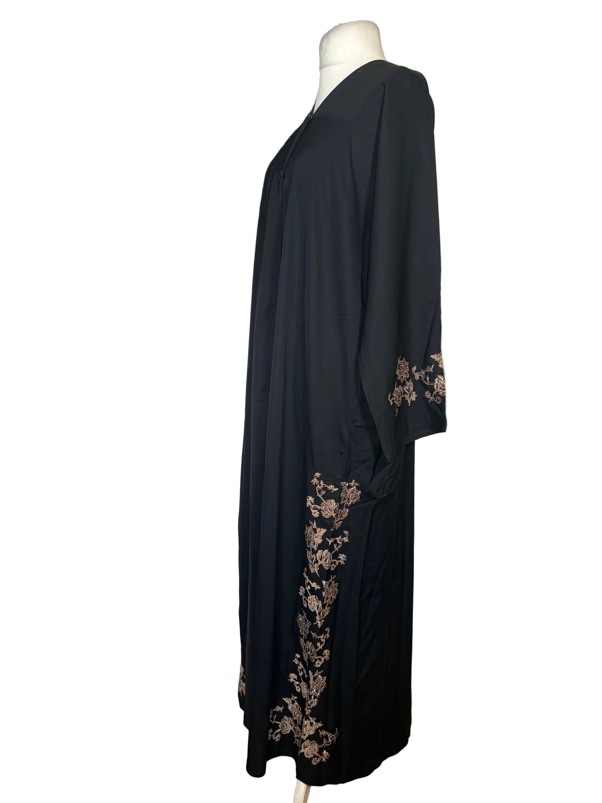 Black Abaya with floral embroidery on a white bedspread