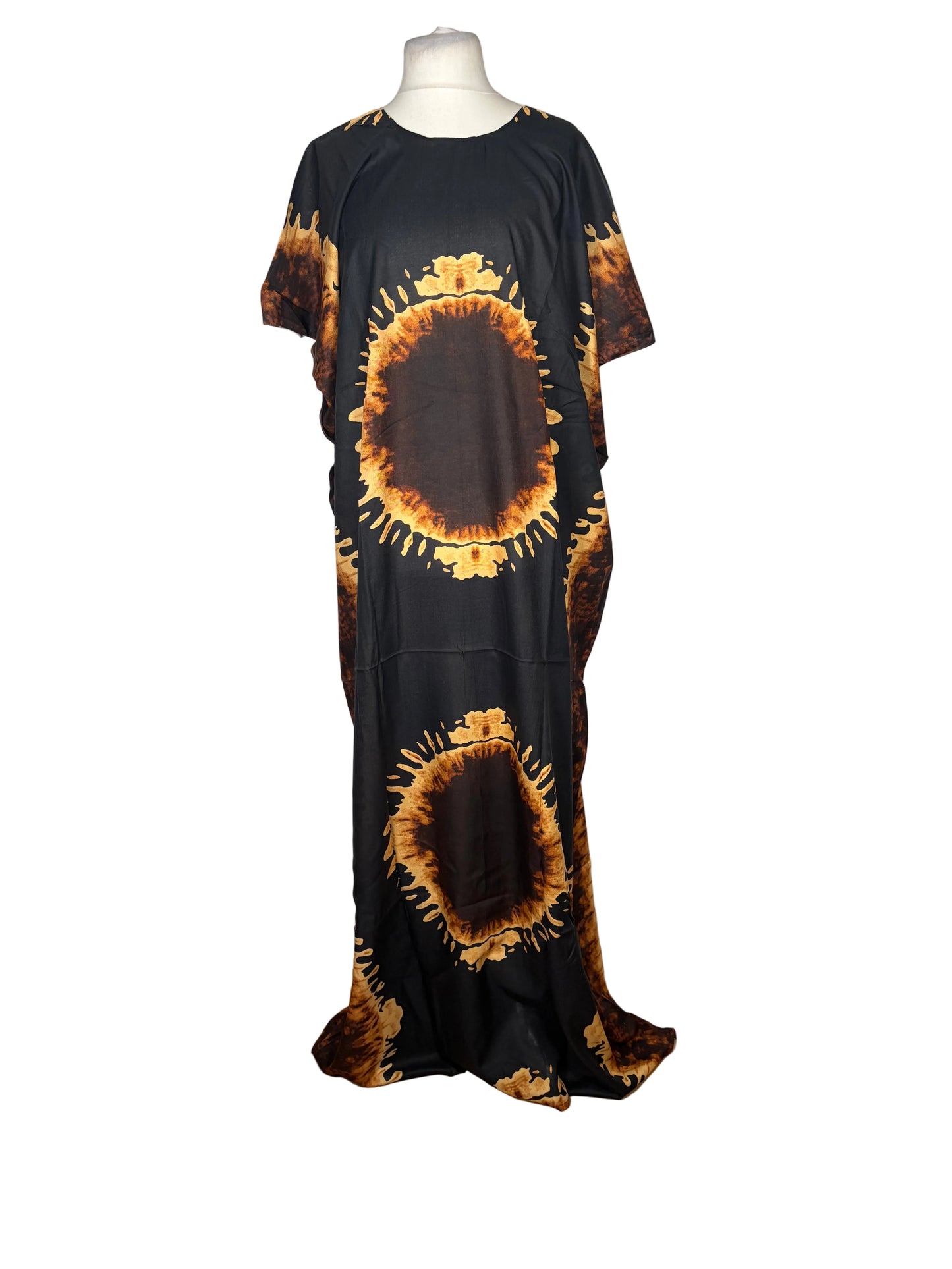 Black dress with sunflower patterns on a mannequin against a white backdrop