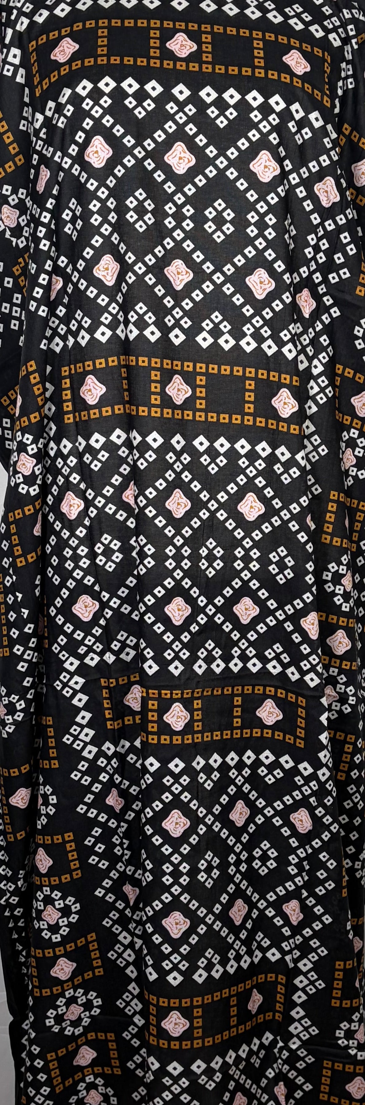Black and white patterned Baati dress on a mannequin against a white background