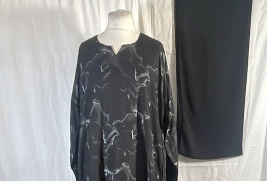 Black marble print one-piece abaya with matching black scarf on a mannequin