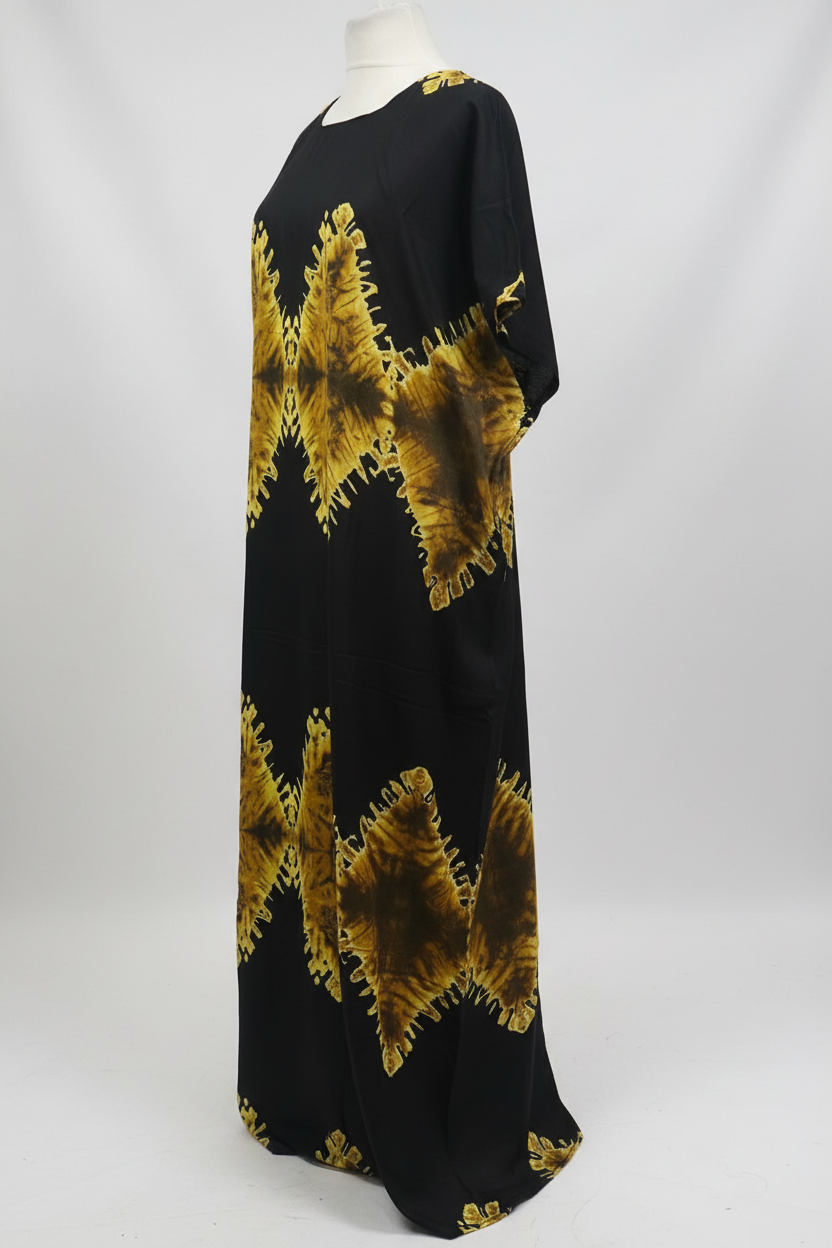 Black Somali baati dress with gold abstract patterns on a white background