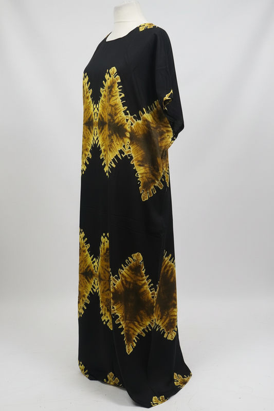 Black Somali baati dress with gold abstract patterns on a white background