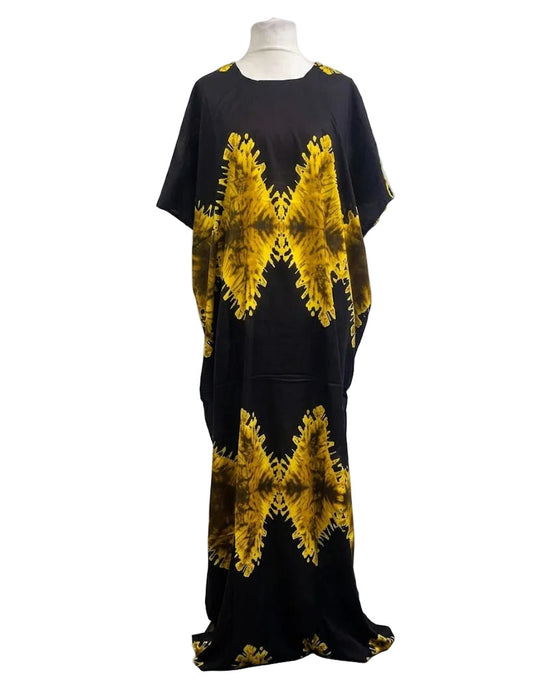 Black Somali baati dress with yellow tie-dye patterns on a mannequin against a white background