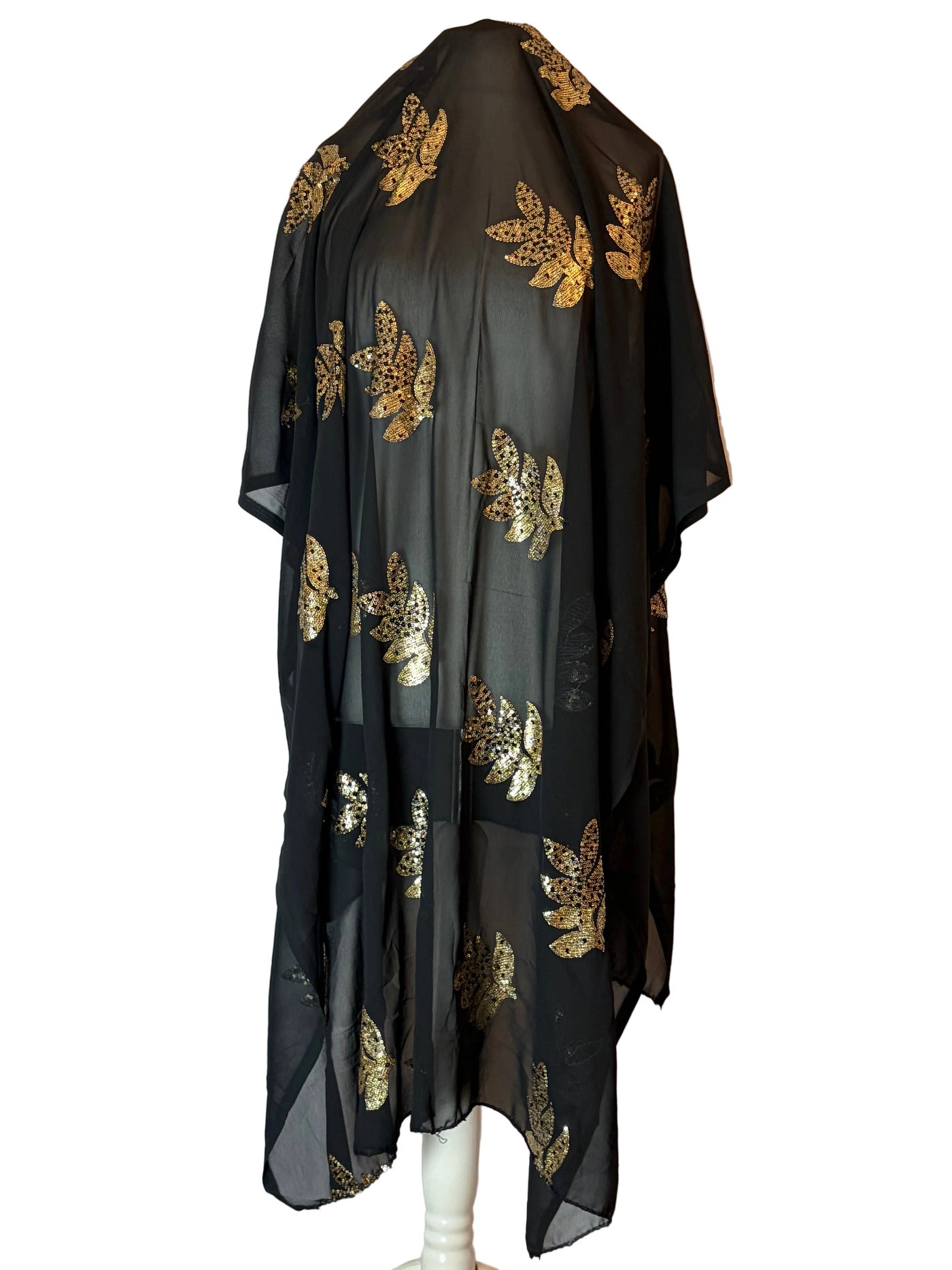 Black Somali Garbasaar fabric with gold patterns on a white background