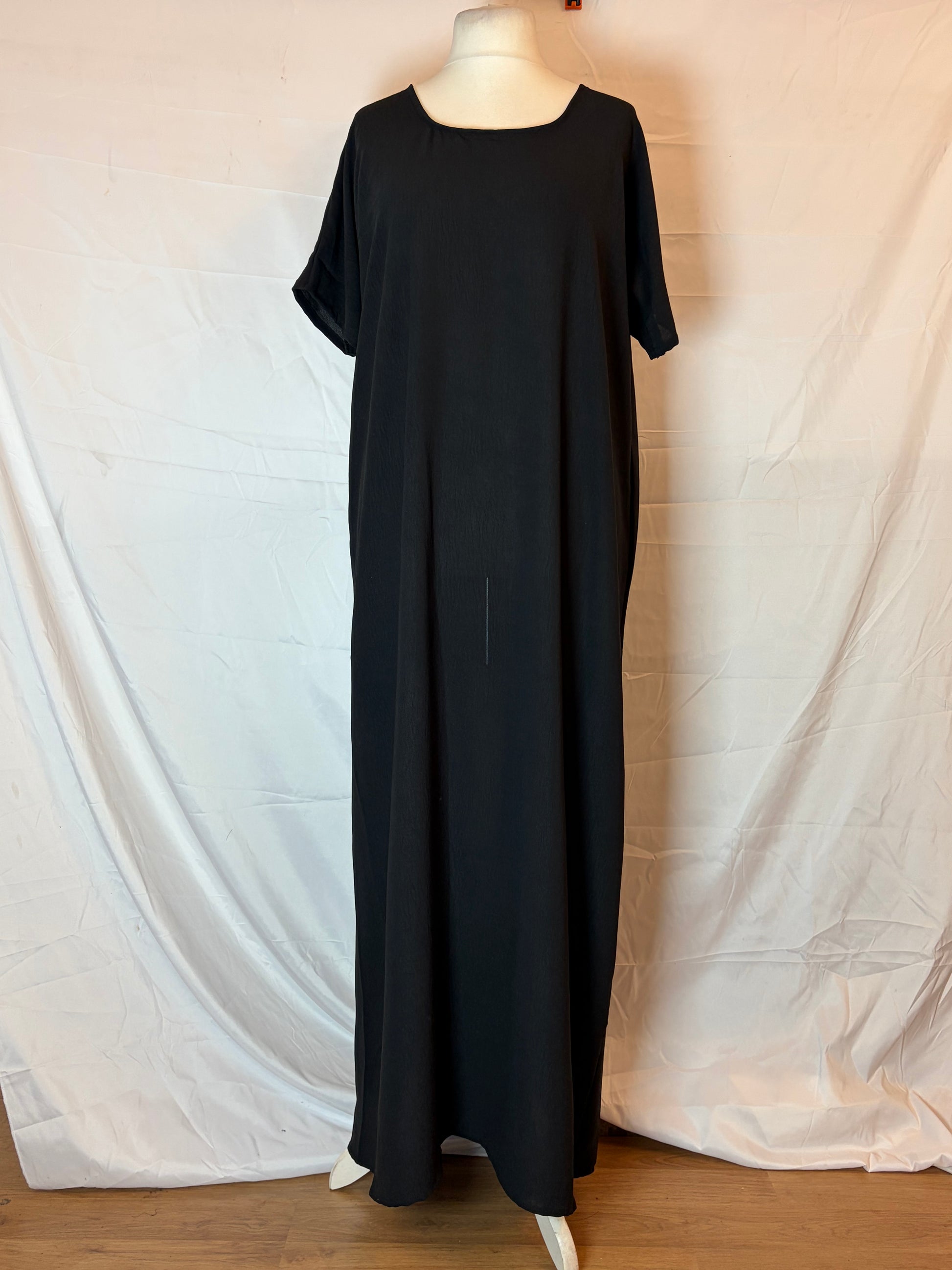 Black dress on a mannequin against a white background