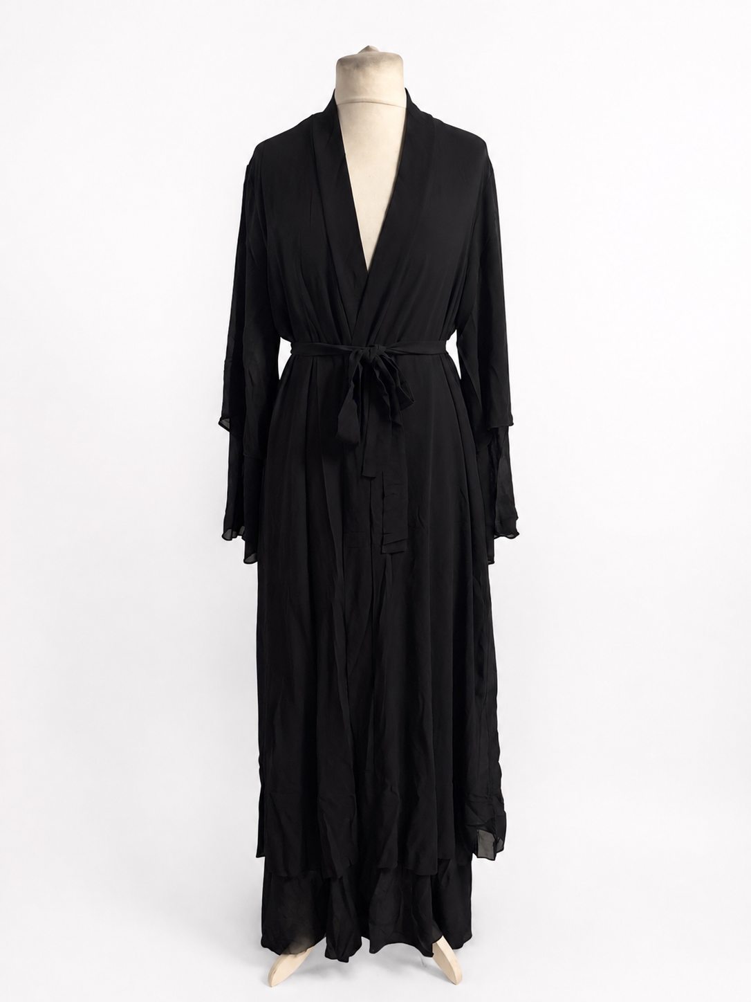 Black dress on a mannequin against a white background
