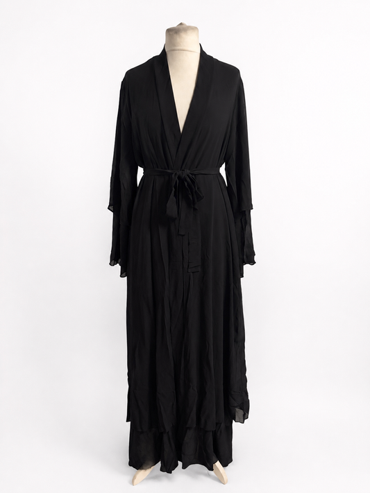 Black dress on a mannequin against a white background